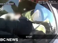 Officer Shoots Driver Clinging to Moving Truck